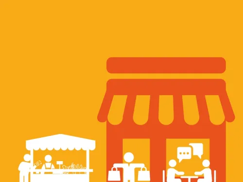 people chatting at a table, a person shopping and a small stall holder